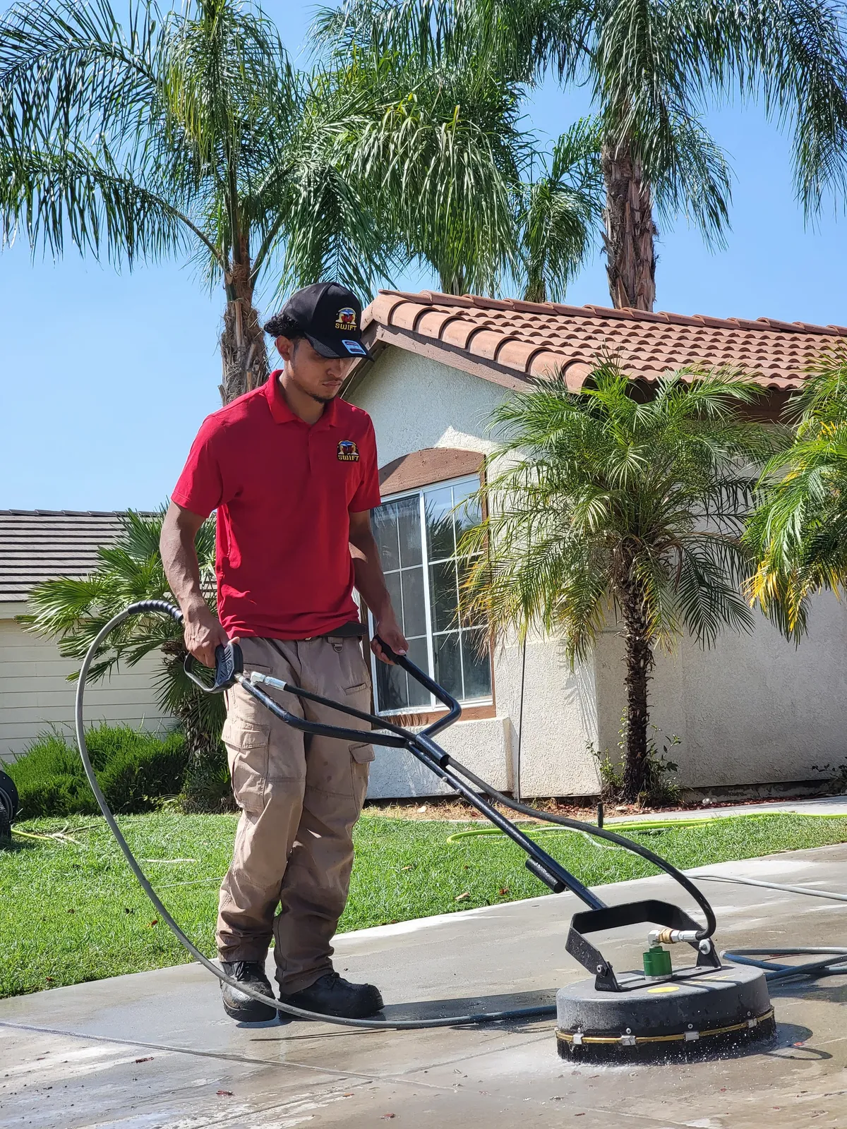 Concrete pressure washing in Bakersfield, CA — BrightSide crew surface cleaning a residential driveway with a flat surface cleaner