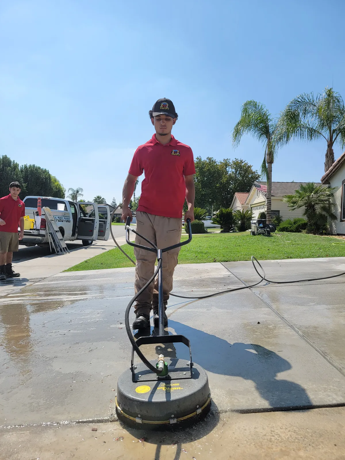 Pressure washing company in Bakersfield, CA — BrightSide Exterior Cleaning crew and work truck on a residential driveway cleaning job